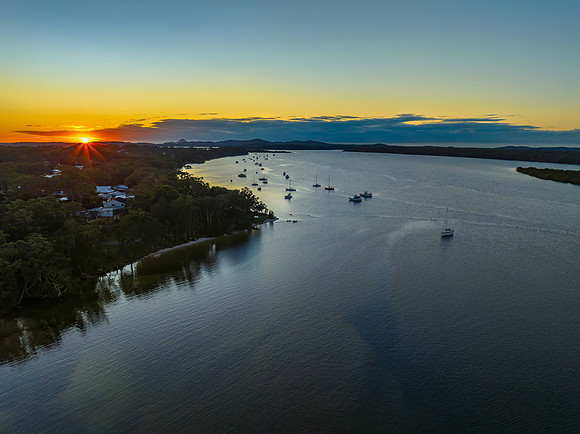 Sunrise over the river with a boat