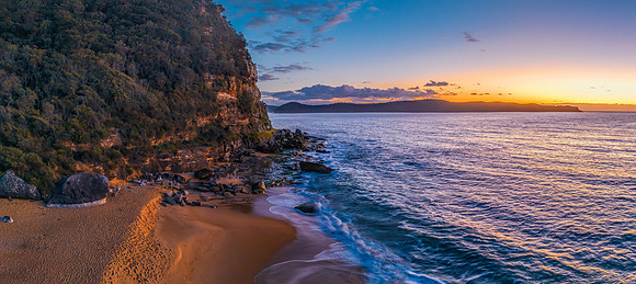 Aerial sunrise panorama over the headland, ocean, rocks and beac