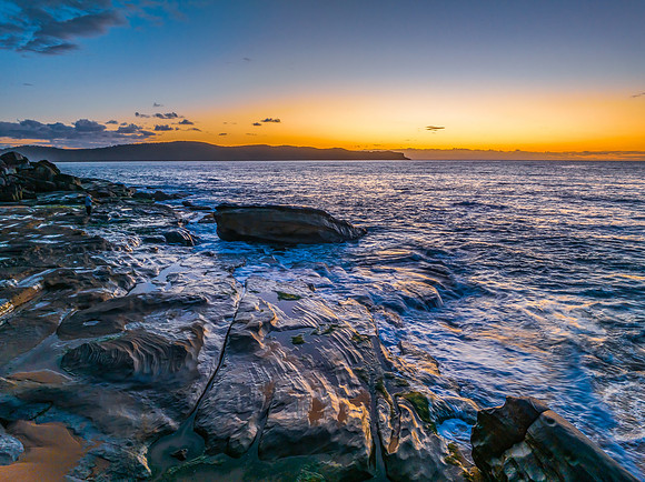 Aerial sunrise views over the ocean and beach
