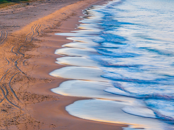 Sunrise at the seaside with the sea washing up on the beach