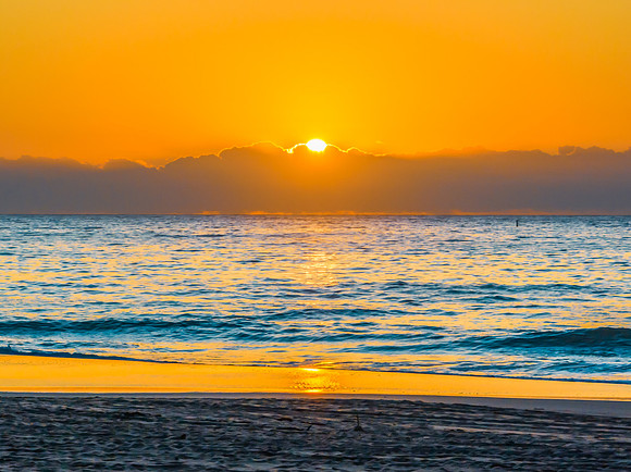 Sunrise at the seaside with orange horizon