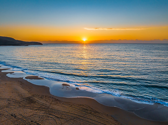 Sunrise at the seaside with orange horizon