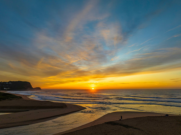 Sunrise and high cloud cover by the sea and lagoon
