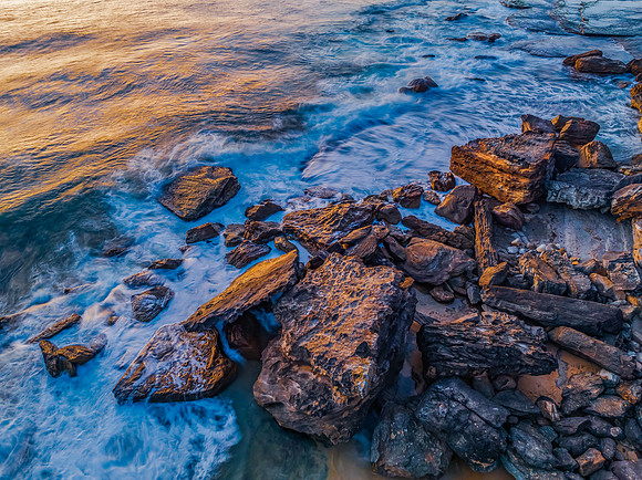 Pretty blue sunrise at the beach with calm seas