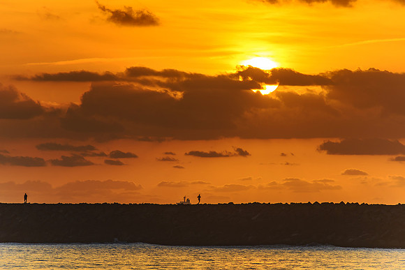 Sun and Silhouettes on the Breakwall Seascape