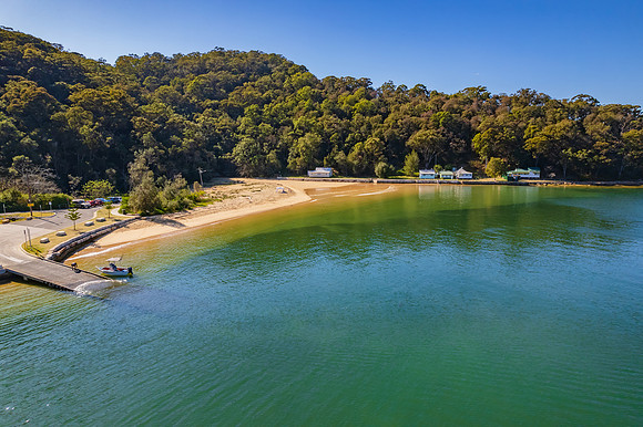 Peaceful morning escape aerial waterscape over the bay with boat
