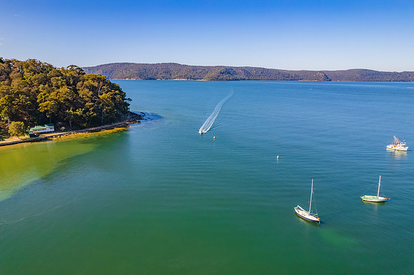 Peaceful morning escape aerial waterscape over the bay with boat