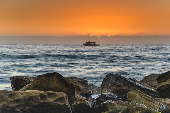 Fishing Boat, Rocks and a Sunrise Seascape