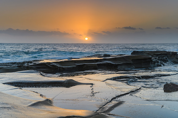 Soft Gold and Blue Hazy Sunrise Seascape from Rock Platform