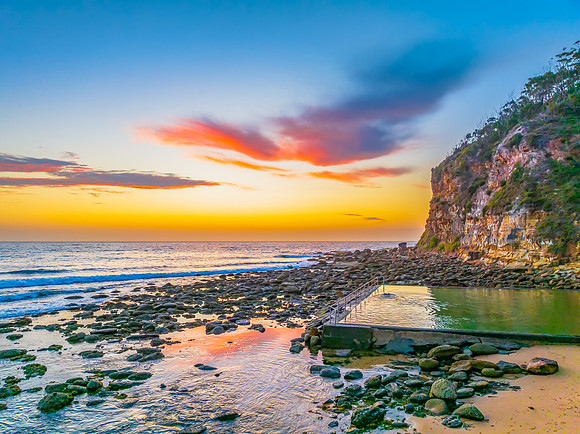 Sunrise at the seashore with colour in the clouds