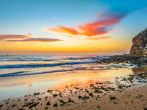 Sunrise at the seashore with colour in the clouds