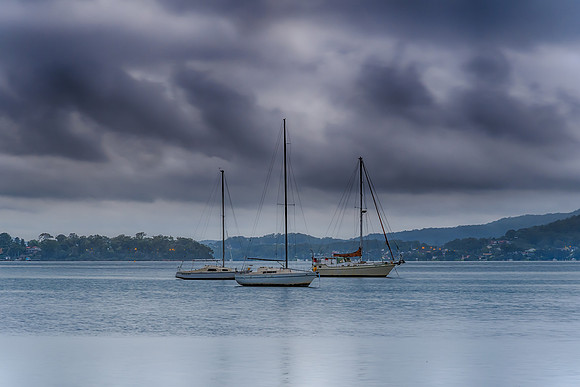 Grey cloudy skies and boats on the bay