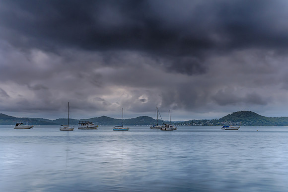 Grey cloudy skies and boats on the bay
