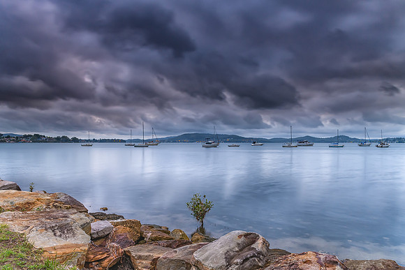 Grey cloudy skies and boats on the bay