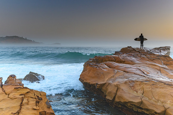 Misty Seascape with Surfer on the Rock