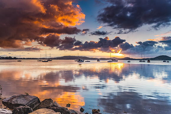 Sunrise and Cloud Reflections on the Bay with Boats