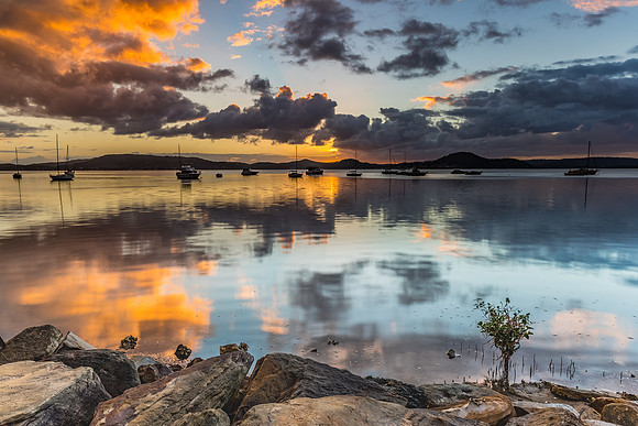 Sunrise and Cloud Reflections on the Bay with Boats