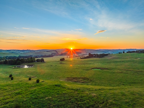 Sunrise over the countryside on the outskirts of country town wi