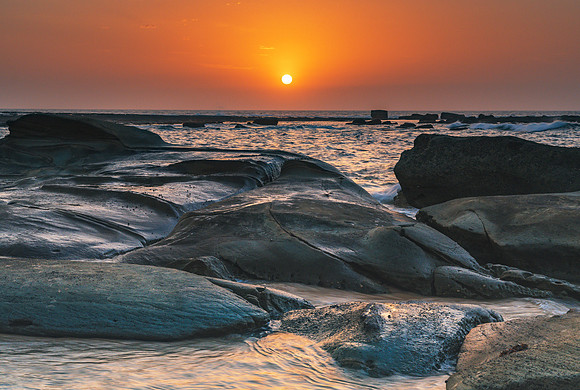 Bold Orange Rocky Coastal Sunrise
