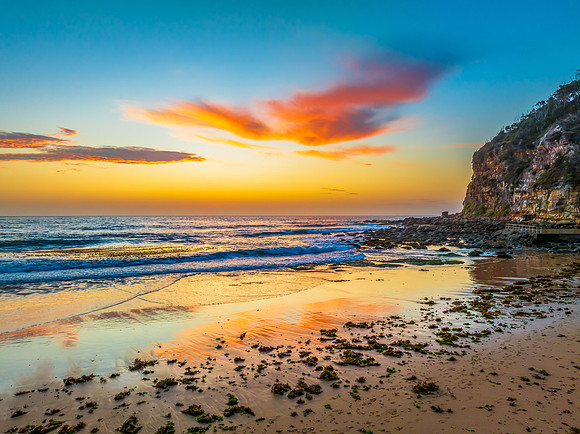 Sunrise at the seashore with colour in the clouds