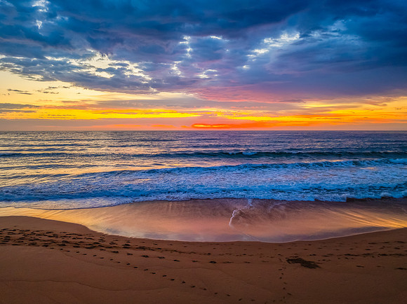 Pretty Sunrise at the seaside with rain clouds