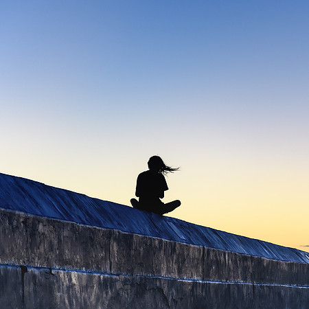 Woman's Silhouette on a wall at Sunrise