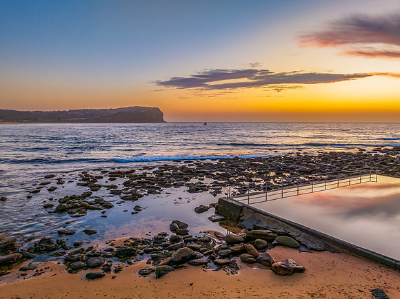 Sunrise at the seashore with colour in the clouds