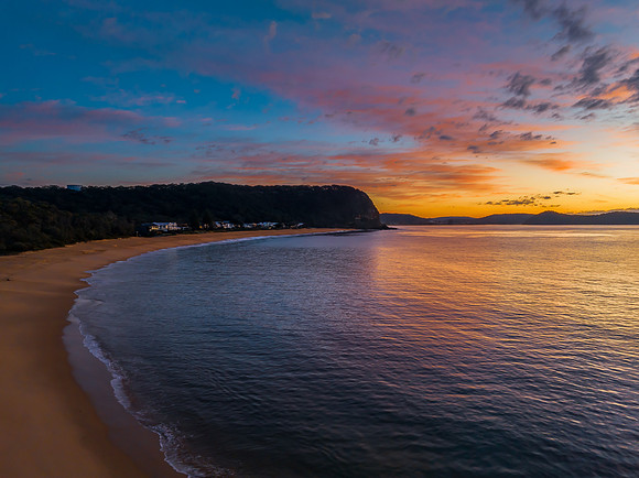 Aerial sunrise seascape with pretty cloud filled sky