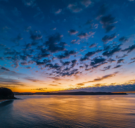 Aerial sunrise seascape with pretty cloud filled sky
