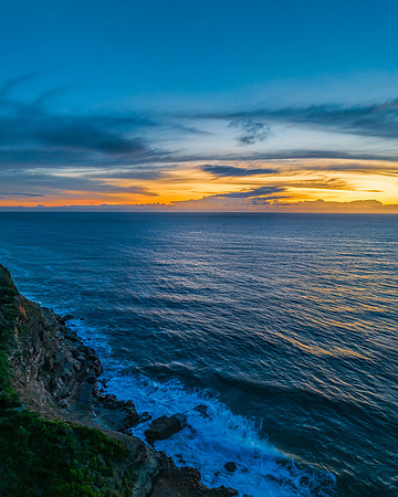Sunrise over the sea and rock platform with high cloud