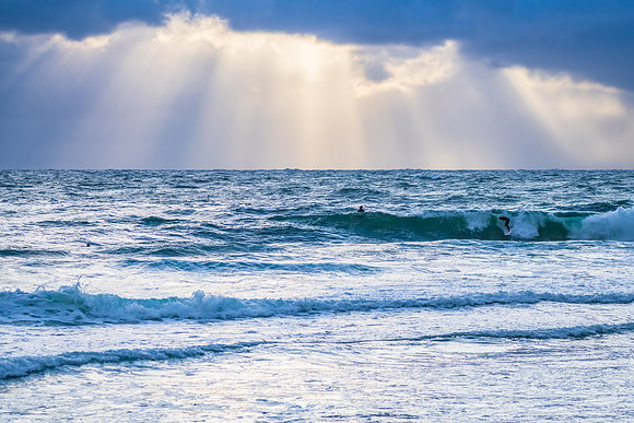 Wet weather sunrise with choppy waves at the seaside