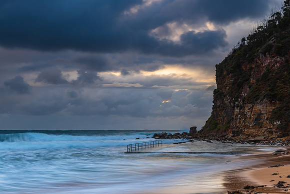Wet weather sunrise with choppy waves at the seaside