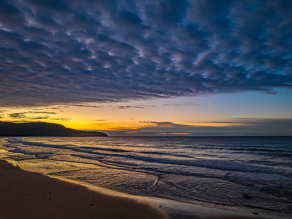 Winter seascape views over the beach with high and medium cloud