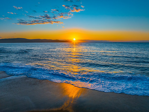 Aerial sunrise views over the ocean and beach