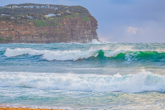 Wet weather sunrise with choppy waves at the seaside