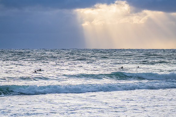Wet weather sunrise with choppy waves at the seaside