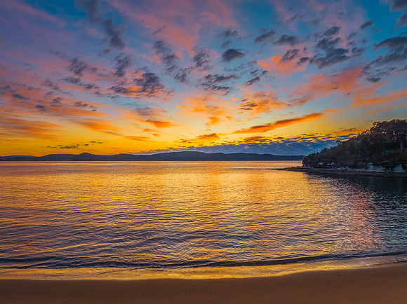 Aerial sunrise seascape with pretty cloud filled sky