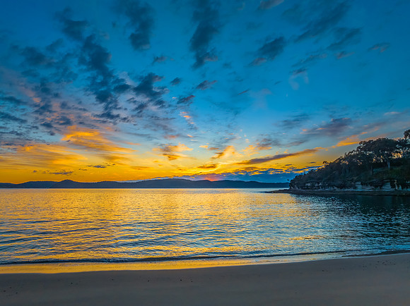 Aerial sunrise seascape with pretty cloud filled sky