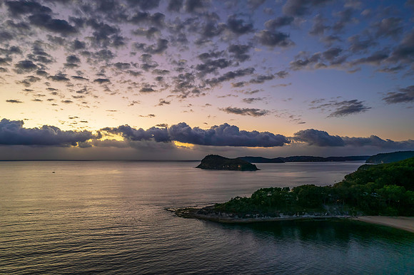 Aerial sunrise seascape with clouds