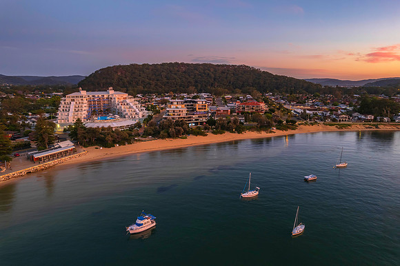 Sunrise shorescape with boats and the town from the channel