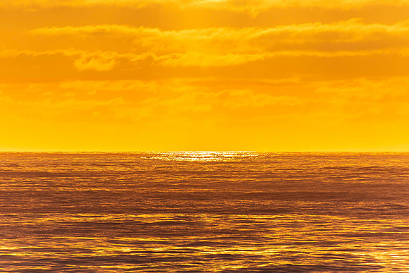 Sunrise seascape with rocky foreground