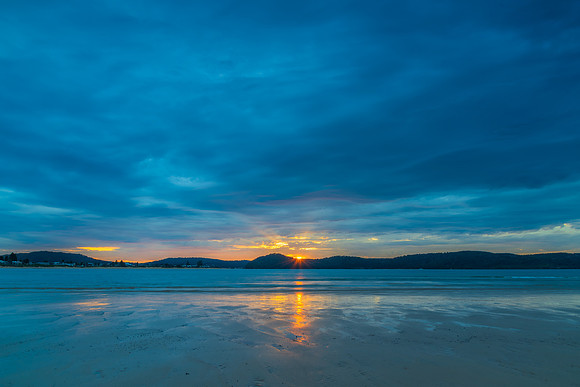 Colourful cloud filled sunrise at the seaside