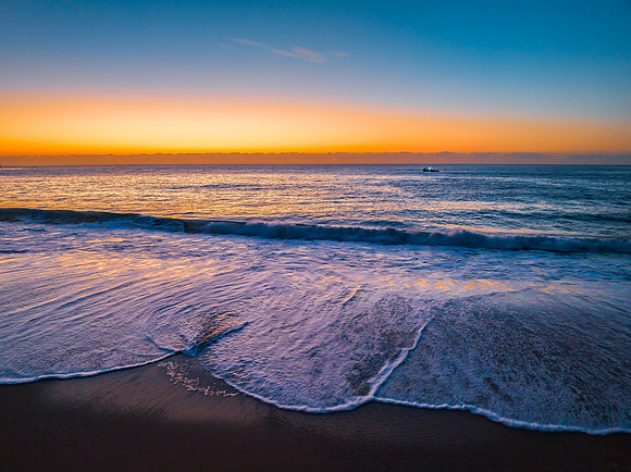 Pretty blue sunrise at the beach with calm seas