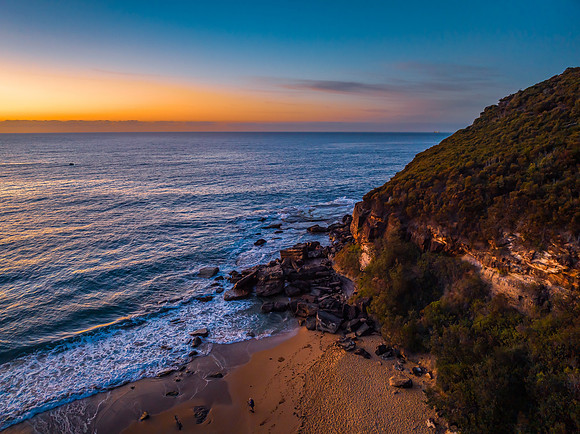 Pretty blue sunrise at the beach with calm seas