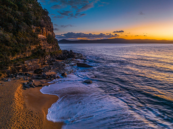 Aerial sunrise views over the ocean and beach