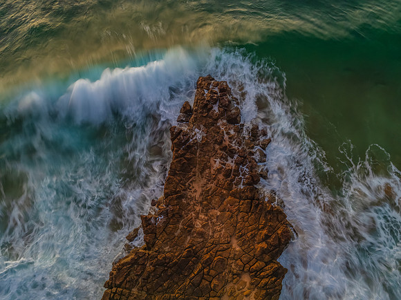 Top down sunrise over the sea and rock platform