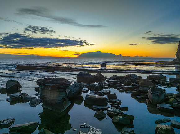 Sunrise over the ocean and rocky Inlet