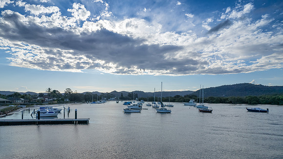 Late afternoon waterscape with boats and rain clouds