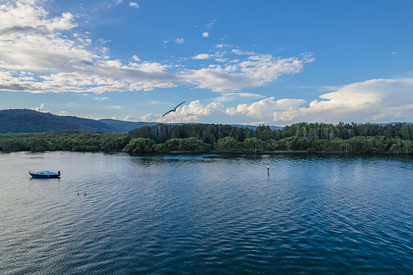 Late afternoon waterscape with boats and rain clouds