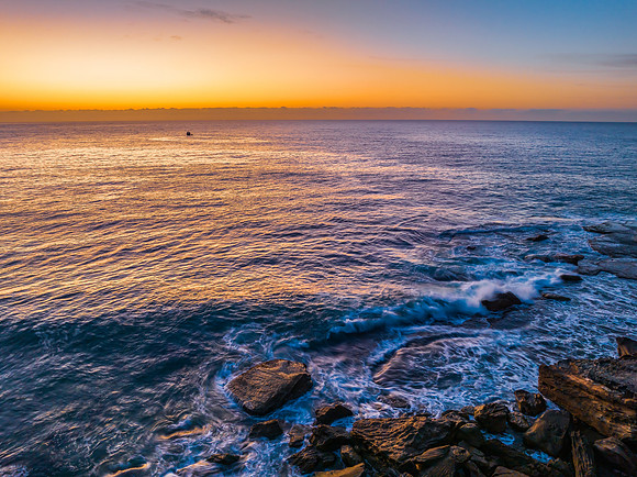 Pretty blue sunrise at the beach with calm seas